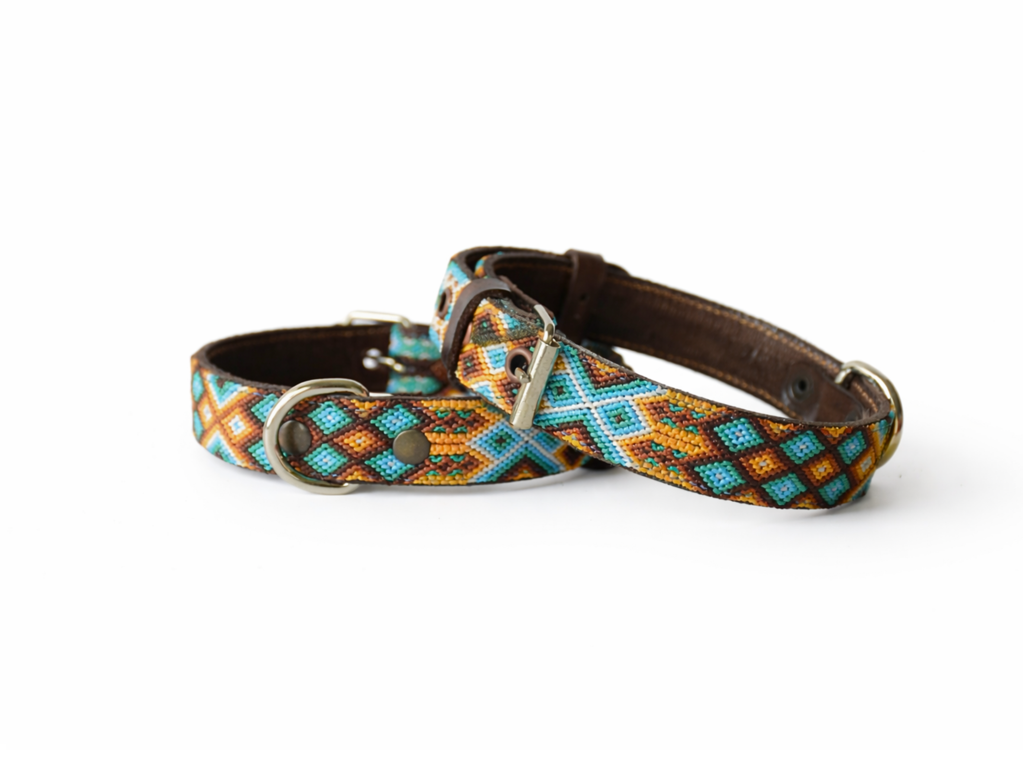 A woven dog collar with a geometric pattern in turquoise, orange, and brown, featuring a dark brown leather strap and silver-tone metal hardware, displayed on a clean white background.